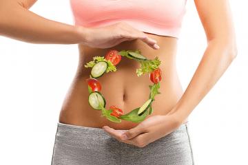 A graphic depicting salad vegetables in a circle in front of a person's stomach