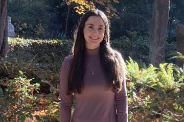 Abigail Bloom standing among trees and bushes