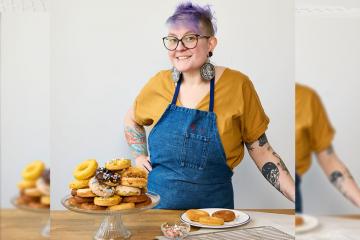Corrie Locke-Hardy standing at a counter with a plate of donuts