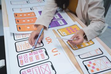 A student working on a phone app by drawing out the components