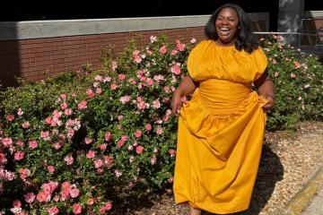 Breanna J. McDaniel wearing a long gold dress
