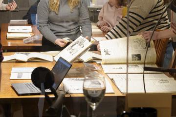 Students working with archives on a table