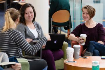 Students enjoying coffee and conversation sitting at the Fens