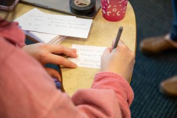 A closeup of a student doing deskwork in a Behavior Analysis class