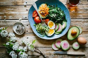A plate of vegetables on a wooden table