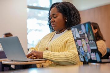Social Work graduate student on laptop.