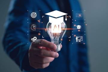 A graphic of a person holding a lightbulb with the letters "AI" on it and a graduation cap on top of it.