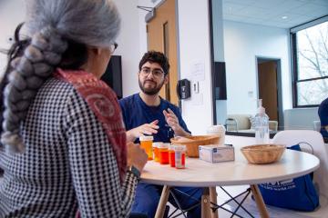 A Simmons nursing student working with "Carlotta" in the home health lab
