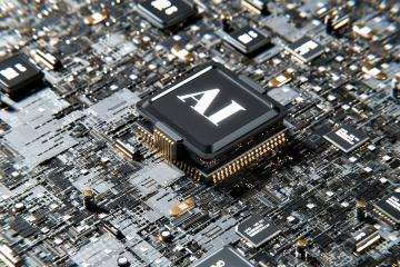 A close-up photo of a microchip where one of the components is labeled AI. Photo courtesy of Unsplash.