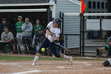 A Simmons softball player taking a swing