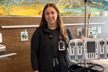 Haley Dover ’22 standing among equipment in a hospital room
