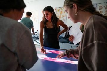 Valeria Caballero and other PT students using an anatomage table