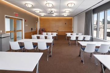 Room C503 setup in classroom style with an aisle down the middle of rectangular tables