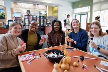 Simmons President Lynn Perry Wooten with a group of students at fall fest