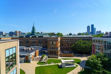 The Simmons University quad with the Boston skyline in the background