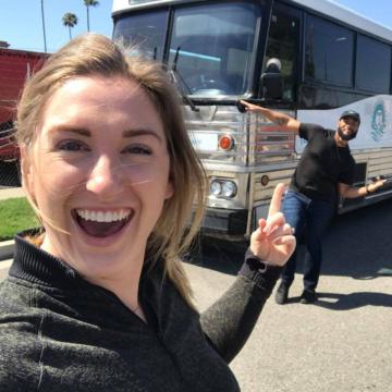 Taylor Paige Nealand in front of her bus.