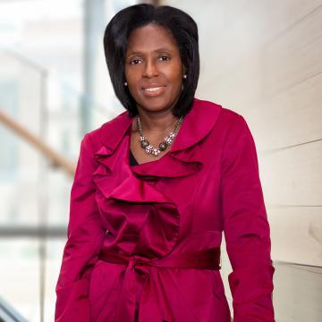 President Lynn Perry Wooten standing on stairs.