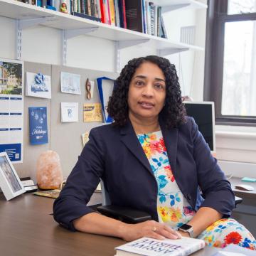 Ammina Kothari, seated at a desk