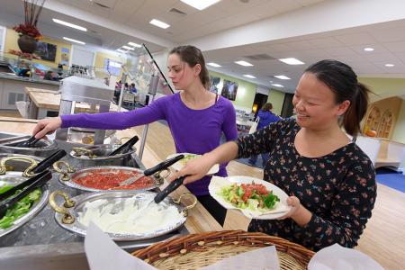 Students eating in dining hall.