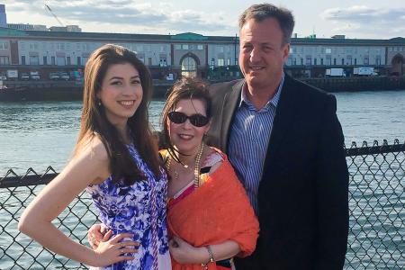 A simmons student standing with her parents