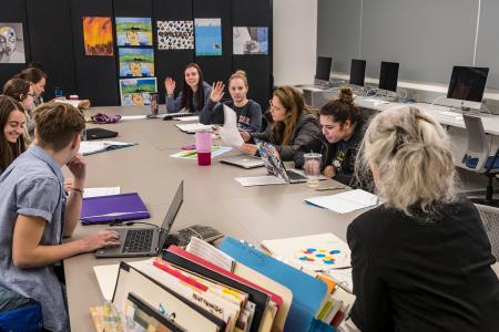 Students looking at art in an art class
