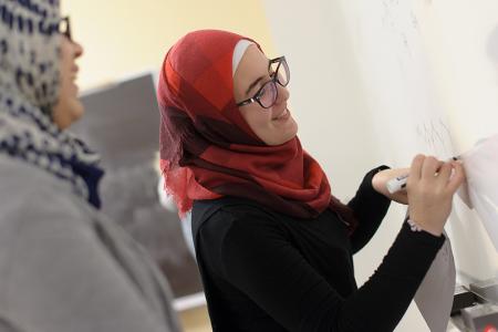 Student writing on a whiteboard