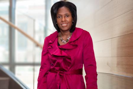 President Lynn Perry Wooten standing on stairs.