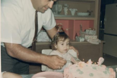 Stacey Pazar Huth and her father Emmanuel Pazar cutting a birthday cake together