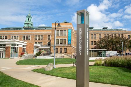 A blue emergency phone located on the Simmons campus