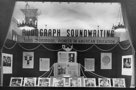 A display case from a 1948 exhibition dedicated to John Simmons’ legacy in business and women’s education, displayed at Atwell Co. on Federal Street in Boston’s financial district, courtesy of Simmons University Archives.