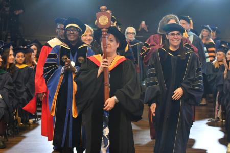 The faculty, including President Lynn Perry Wooten an Provost Stephanie Cosner, process into the 2025 Commencement ceremony