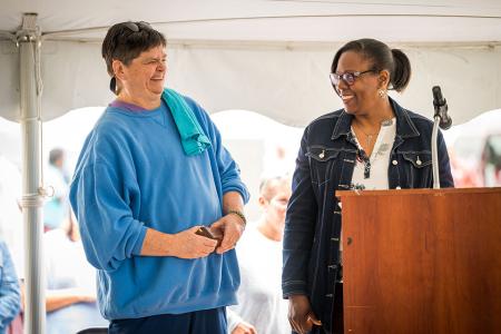 Regina Marshall, Advocates president and CEO (right) presenting Caroline Miller, Advocates peer support coordinator (left) with an award at the 2026 Advocates annual staff and community BBQ.
