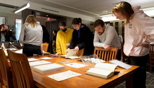 Students studying manuscripts in the Simmons library archives