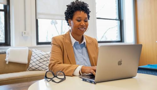 Student working on laptop in office space