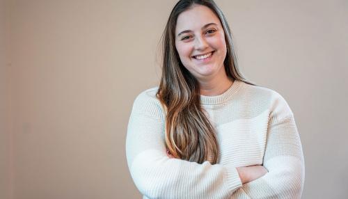 A Simmons student wearing a white sweater and smiling 