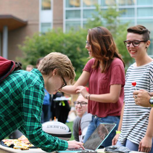 Students at an event on the residential quad
