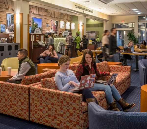 Students sitting in a common area in the Main College Building at Simmons University