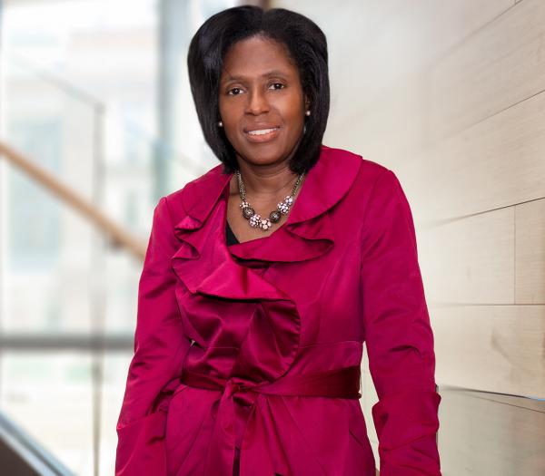 President Lynn Perry Wooten standing on stairs.
