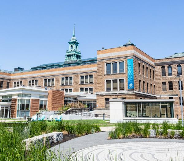 Main Campus Building exterior within the campus quad on a bright, sunny day