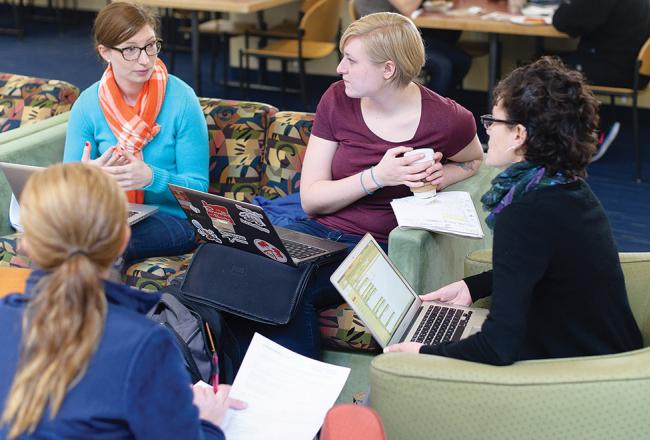 Students sitting in the common area of the Main College Building