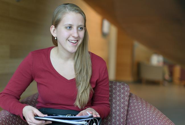 Student sitting with books