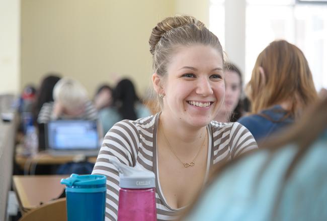 Student smiling at another student