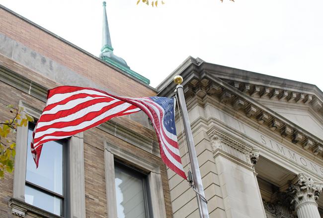 American flag in front of the Main College Building at Simmons University