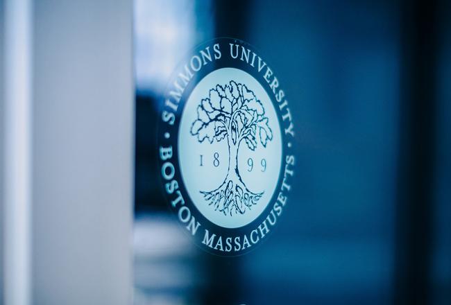 Simmons University logo on a wall