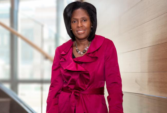 President Lynn Perry Wooten standing on stairs.