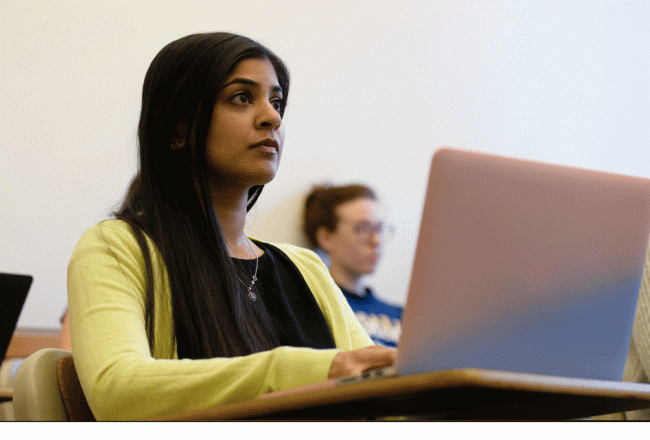 Student sitting at a computer during a seminar.