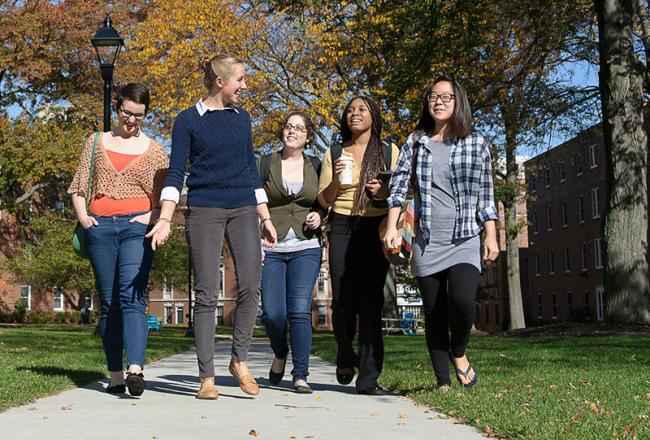Simmons students walking across residential campus
