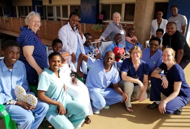 Marilyn Riley with a group of patients and others involved with Team Heart in Rwanda