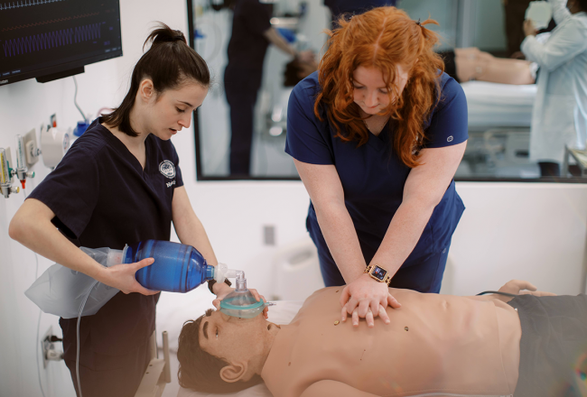 Students simulating giving CPR to a patient in the Nursing Simulation Center