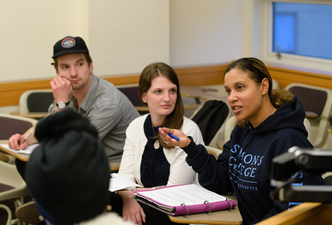 Three graduate students in a classroom at Simmons University